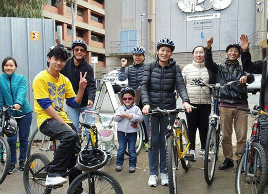A group of people who just received repaired bikes
