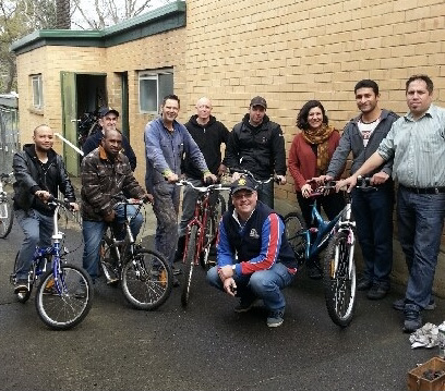 A group of people standing with their donated bikes