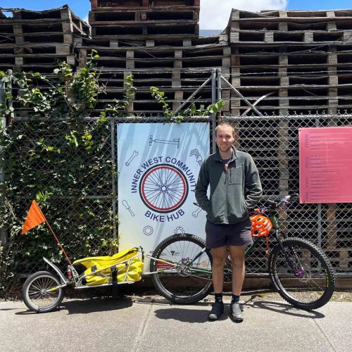 James standing with his bike in front of the Inner West Bike Hub