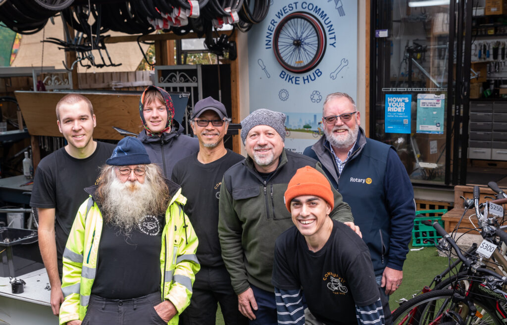 Group of mechanics and volunteers at the front of Community Bike Hub workshop