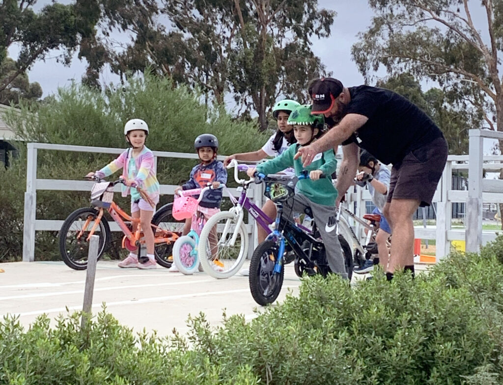 children on bikes learning with instructor