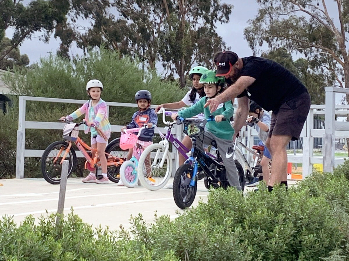 children on bikes learning with instructor